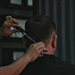 barber cutting man's hair