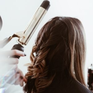 person holding gray hair curler